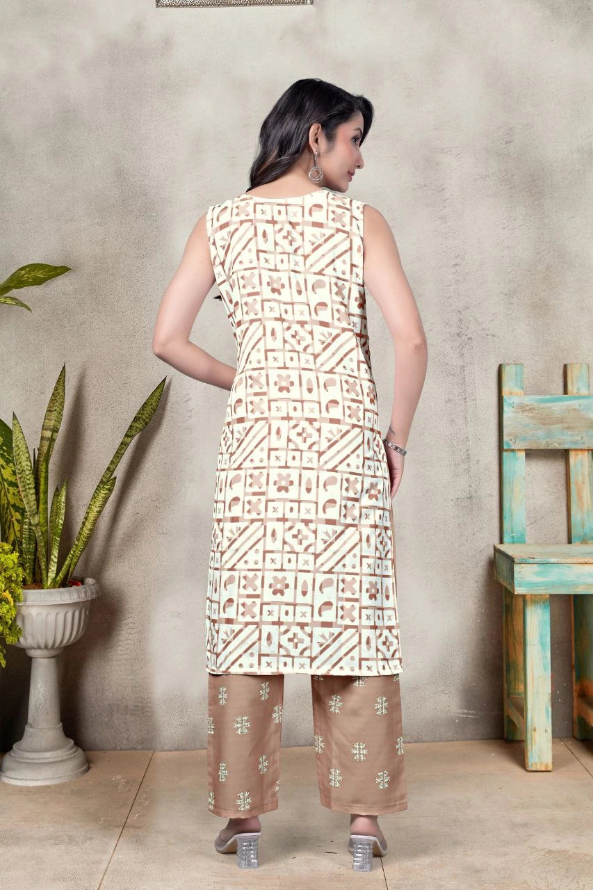Woman wearing a patterned kurta with palazzo pants standing against a textured wall.